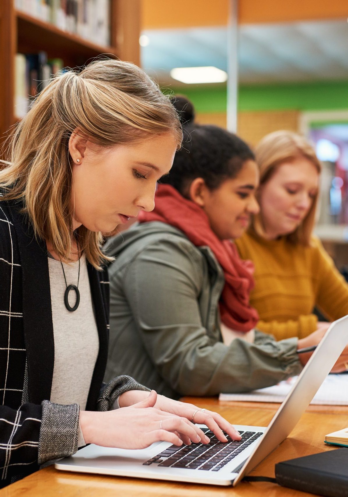 Laptop,,Typing,And,Woman,In,Library,For,Study,Group,With